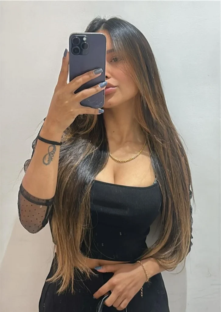 Alline poses for a photo in the mirror. You can notice her beautiful tattoos, which perfectly emphasize her shape