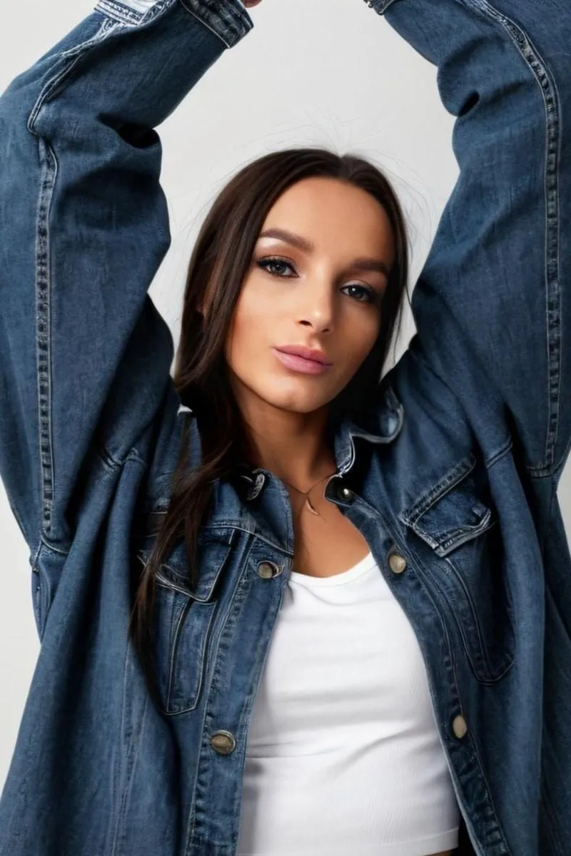 Oryana – stylish Central London escort in denim jacket with arms raised